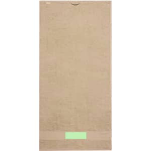 A beige hand towel featuring a smooth texture and a simple design, with a logo at the bottom.