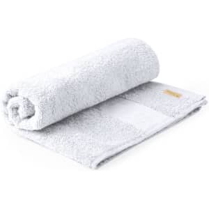 A rolled grey towel, featuring a textured surface and a small logo. It's plush and designed for bath use.