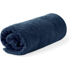 A rolled navy bath towel with a soft, fluffy texture and a branding logo.
