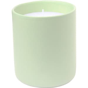 A pale green aromatic candle in a round container, featuring a white wax interior. The candle has a simple design.