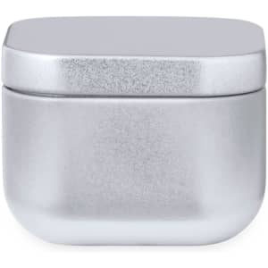A silver aromatic candle in a sleek, modern jar with a smooth, rounded design and a flat lid.