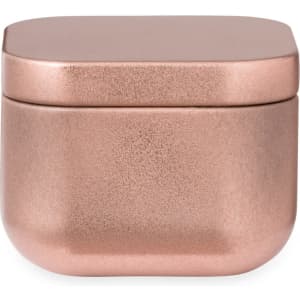 A metallic rose gold candle container with a smooth, rounded design and a secure lid.