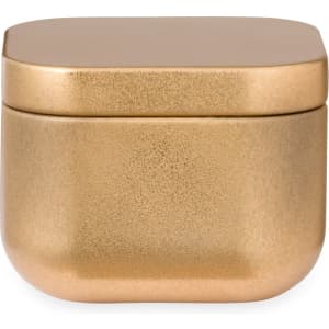 A metallic gold candle container featuring a rounded, square design and a smooth lid.