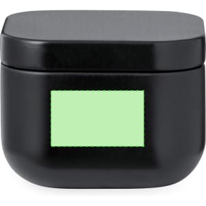 A black aromatic candle in a rounded container with a flat top and a green label area.