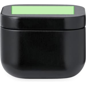 A black aromatic candle in a sleek, rounded container with a green top. It features a logo on the front.