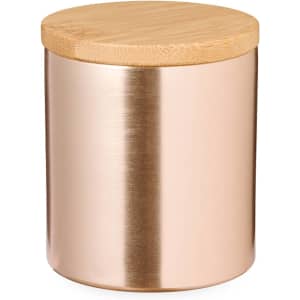 A copper and bamboo aromatic candle jar with a smooth finish and a wooden lid.