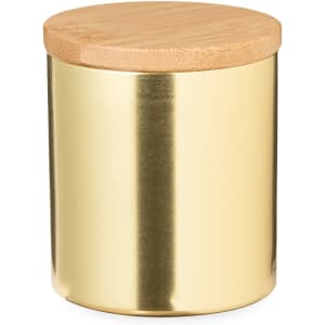 A gold candle jar with a bamboo lid, featuring a shiny finish. It has a sleek, modern design.