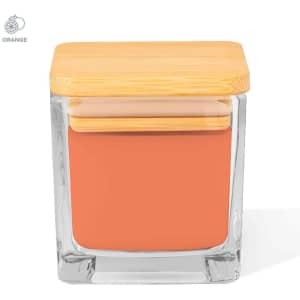 A glass jar candle with a wooden lid, featuring a warm orange wax inside.