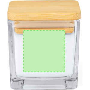 A square glass candle jar with a bamboo lid, featuring a white base and a blank green label.