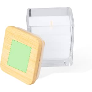 A square glass candle with a white wax and a bamboo lid featuring a green square.