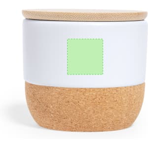 A white and cork aromatic candle with a bamboo lid, featuring a green label on the front.