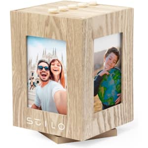A wooden photo frame in a cube shape with space for two images, featuring a light wood finish and a logo.