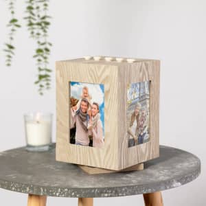A wooden photo frame with multiple sides for displaying photos, featuring a light natural finish and a simple, modern design.