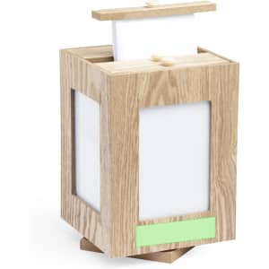 A wooden photo frame with a light oak finish, featuring openings for photos and a lid on top. It has a branding logo.