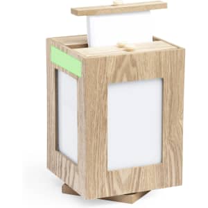 A wooden photo frame in a light oak finish, featuring four picture slots and a removable lid.