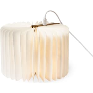 A lamp with a flexible, pleated white shade and a wooden base, showcasing a warm glow and a power cord.