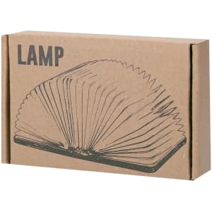 A boxed lamp with a unique book-like design, featuring an illustration on a brown cardboard package.