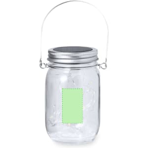 A clear glass lantern with a metal handle and silver lid, featuring a blank green label.