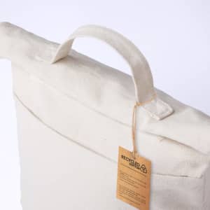 A cooler bag in natural recycled cotton with a top handle and a tag attached.