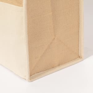 A tan cooler bag features a textured design and structured bottom for stability, with an unobtrusive logo.