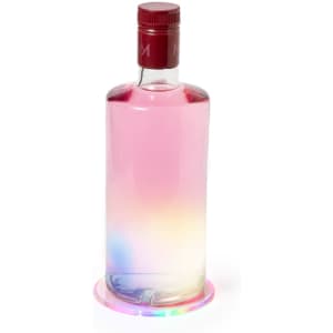 A drink bottle with a red cap sits on a rainbow-hued coaster, featuring an iridescent design.