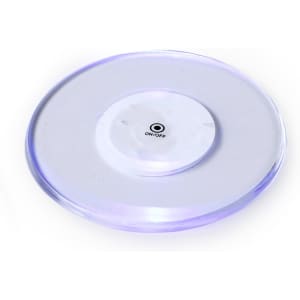 A round, translucent coaster with a purple glow and a small switch on the base. It features a logo.