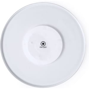 A round white coaster with a central button marked “ON/OFF” on the underside and a small logo.
