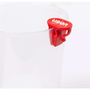 A clear plastic cup with a red clip attached, featuring a logo on the clip.