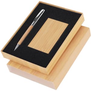 A wooden gift box containing a pen and a business card holder, both with a natural finish, featuring a black padding.