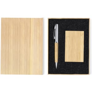 A bamboo notebook and pen set neatly packaged in a box with a black foam insert.