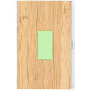 A wooden notebook with a natural finish and a green patch on the cover. It features a branding logo.
