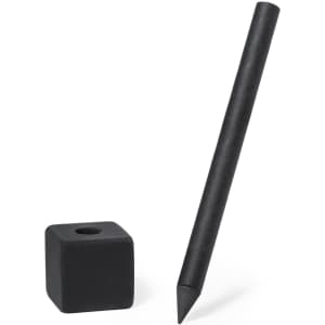 A black grey-lead pencil is positioned next to a black cube eraser. The pencil features a pointed tip.