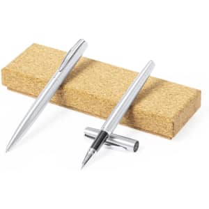 A set of silver metal pens placed on a cork stand. The pens have sleek designs and feature a branding logo.