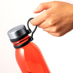 A drink bottle in vibrant red with a silver lid and a black handle, featuring a logo on the side.