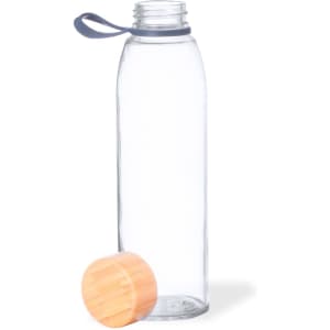 A drink bottle made of clear glass with an orange wooden lid and a grey silicone strap.