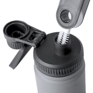 A drink bottle in grey with a detachable brush and a flip-top lid, featuring a logo on the side.