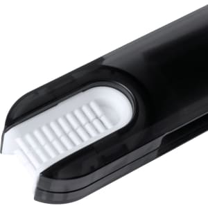 A black cleaning brush with a textured white bristle area, designed for cleaning purposes, featuring a sleek design.