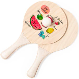 Two wooden beach rackets featuring colourful fruit illustrations, including a watermelon, lemon, and strawberries, with a white ball.