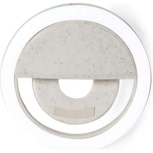 A round, white Traxo Ring Light with a textured inner section. Features a simple design and includes a branding logo.