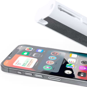 A white cleaning cloth with a textured black side beside a smartphone displaying various app icons.