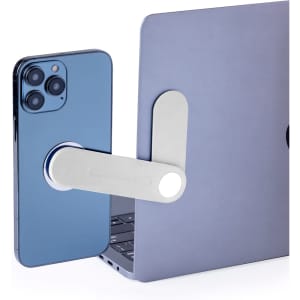 A silver phone holder extends from a laptop, securely holding a blue smartphone in place.