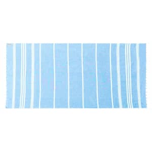 A light blue towel with white striped patterns and fringed edges, featuring a branding logo.