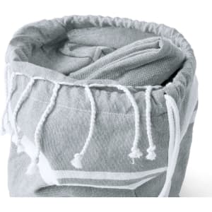 A grey drawstring bag with white decorative details, neatly rolled and tied at the top.