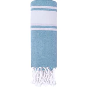 A blue and white striped drawstring bag pareo with fringe detailing. It features a logo on the side.