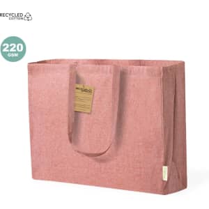 A pink tote bag made of recycled cotton with sturdy handles and a tag attached. It has a simple, minimalist design.