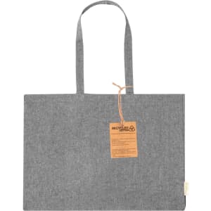 A grey tote bag with long handles and a tag attached, featuring a logo and made from recycled material.