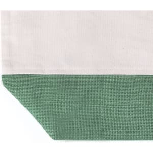 A tote bag featuring a natural canvas top and a textured green bottom, complete with a logo.