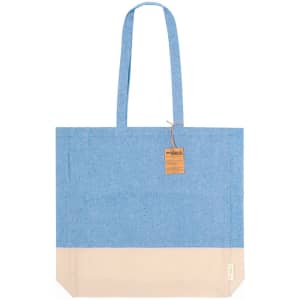 A tote bag featuring a blue upper section and a cream lower section, with a label attached.