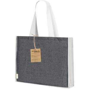 A tote bag in grey with white handles, featuring a tag and made from recycled materials.