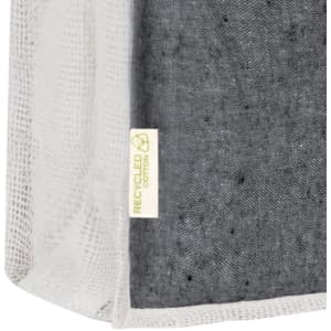 A grey and white tote bag made from recycled cotton, featuring a label indicating its material.